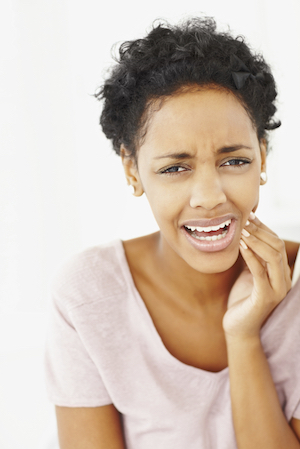 Woman with toothache can find an emergency dentist appointment at Chris Johns, DDS in Millbrae, CA.
