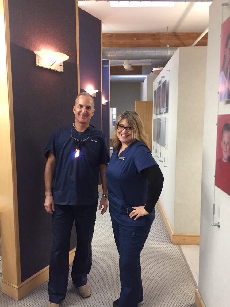 Dentist Chris Johns and Ronnie at the Millbrae, CA dentist office where people can get cleanings and root canal treatment. 